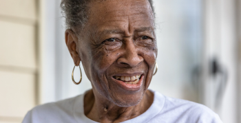A smiling African American woman from the Cheery Community