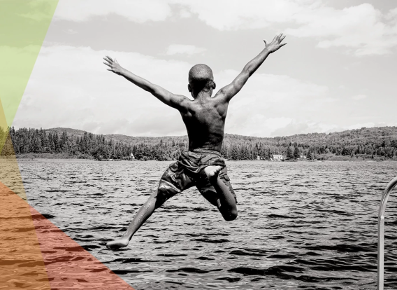 A black and white photo of a person jumping into a lake